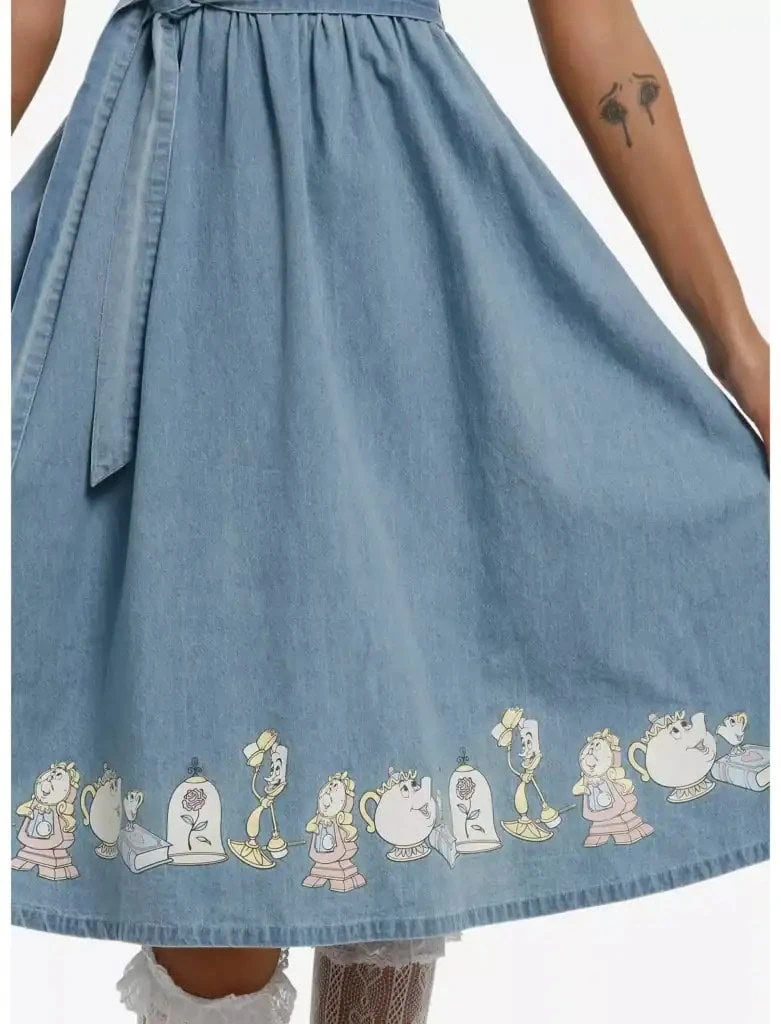 Colorful Disney-themed artwork decorates the bottom hem of a stylish blue denim skirt.
