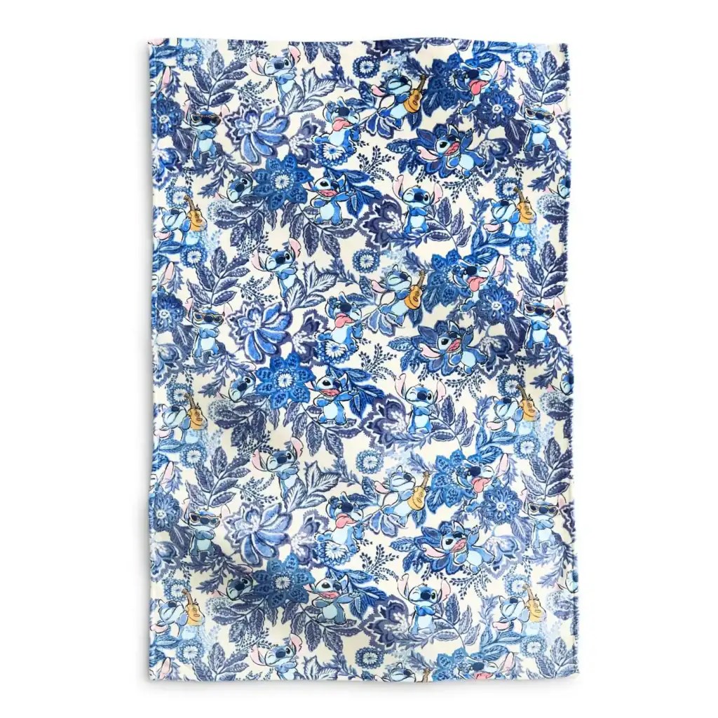 Vibrant blue Stitch floral print fabric, perfect for Disney-themed fashion and sewing projects.