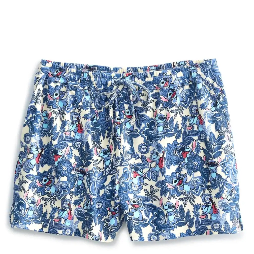 Bright blue floral Disney Stitch patterned swim shorts for kids. Summer beachwear, Disney fashion, kids' swim trunks.
