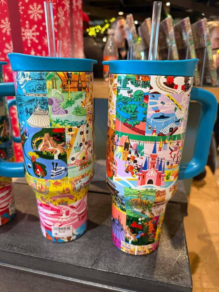 Colorful Disney park map mugs featuring iconic Disney attractions and characters, ideal for Disney fans and collectors.