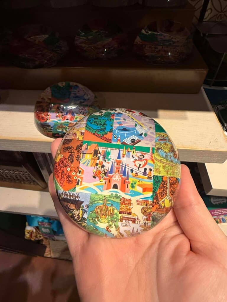 Colorful Disney castle puzzle souvenir for Disney fans and collectors, featuring iconic park scenes and characters.