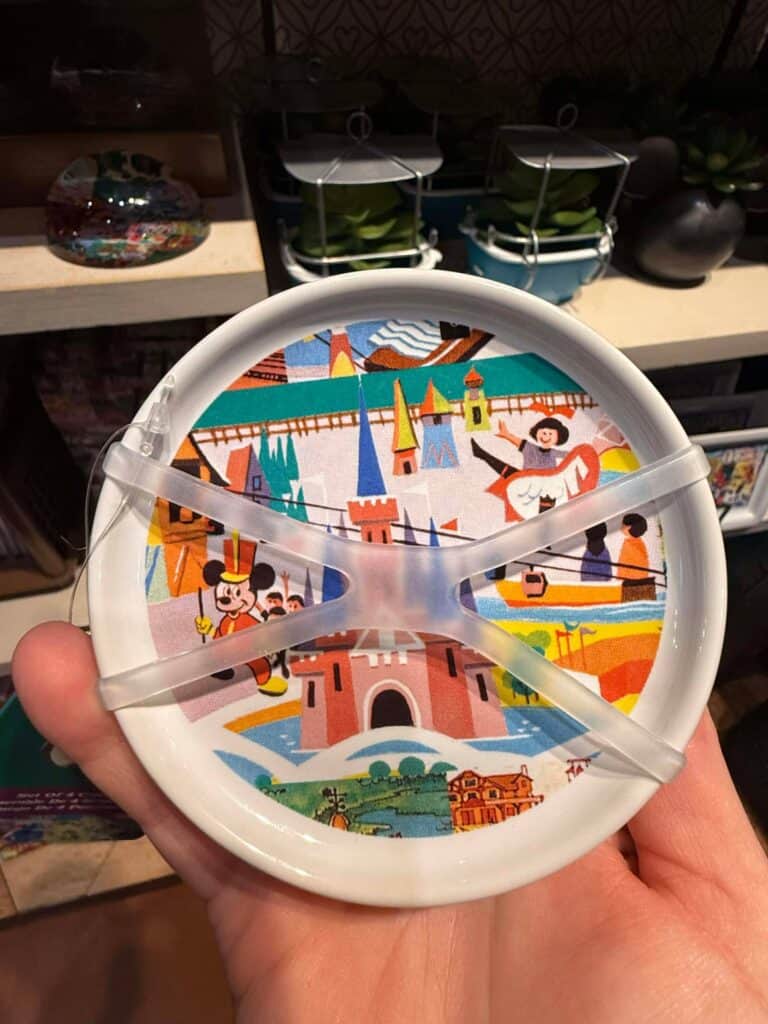 Colorful Disney castle-themed towel holder with Minnie Mouse and other Disney characters. Perfect for Disney fans.