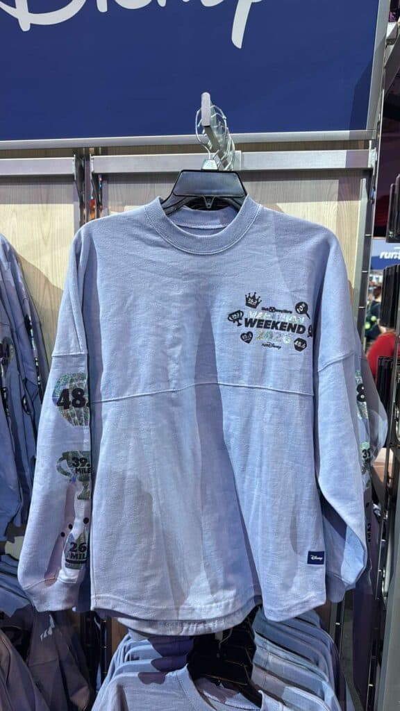 A light gray Disney sweatshirt featuring weekend race track graphics and colorful race elements on sleeves, perfect for Disney fashion lovers.