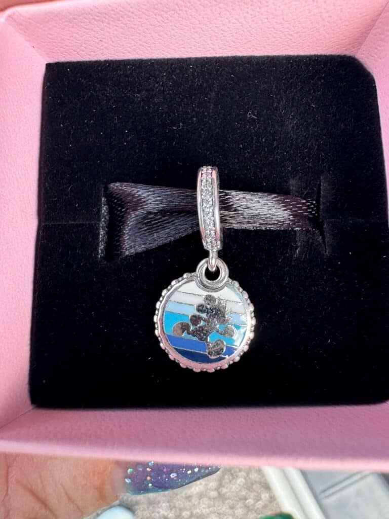 Enchanted Disney Mickey Mouse charm bracelet with sparkling stones in a pink jewelry box.