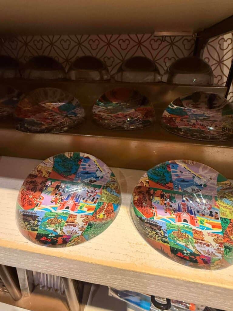Colorful Disney-themed Mickey Mouse glass paperweights with iconic castle design.