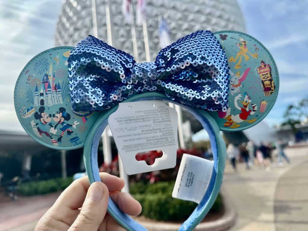 Vintage Disney Mickey Mouse ear headband featuring a glittery blue sequin bow. Perfect Disney accessory for theme parks or events.
