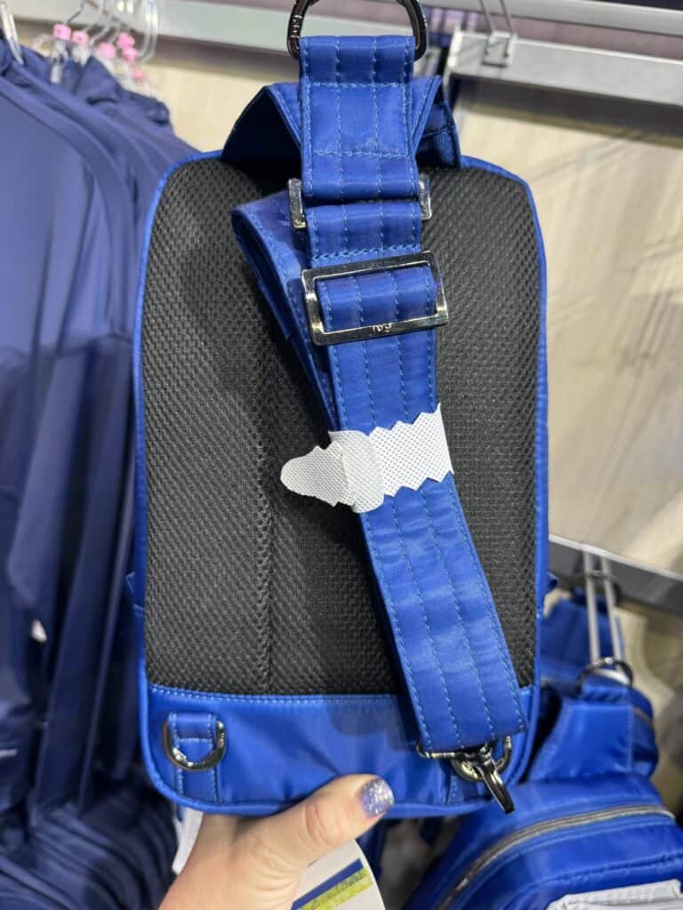 Colorful Disney backpack with adjustable straps and duck charm, perfect for Disney fans and fashionistas.