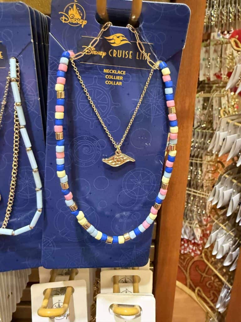 Bright bead necklace featuring a golden ship pendant, perfect for Disney cruise fans.