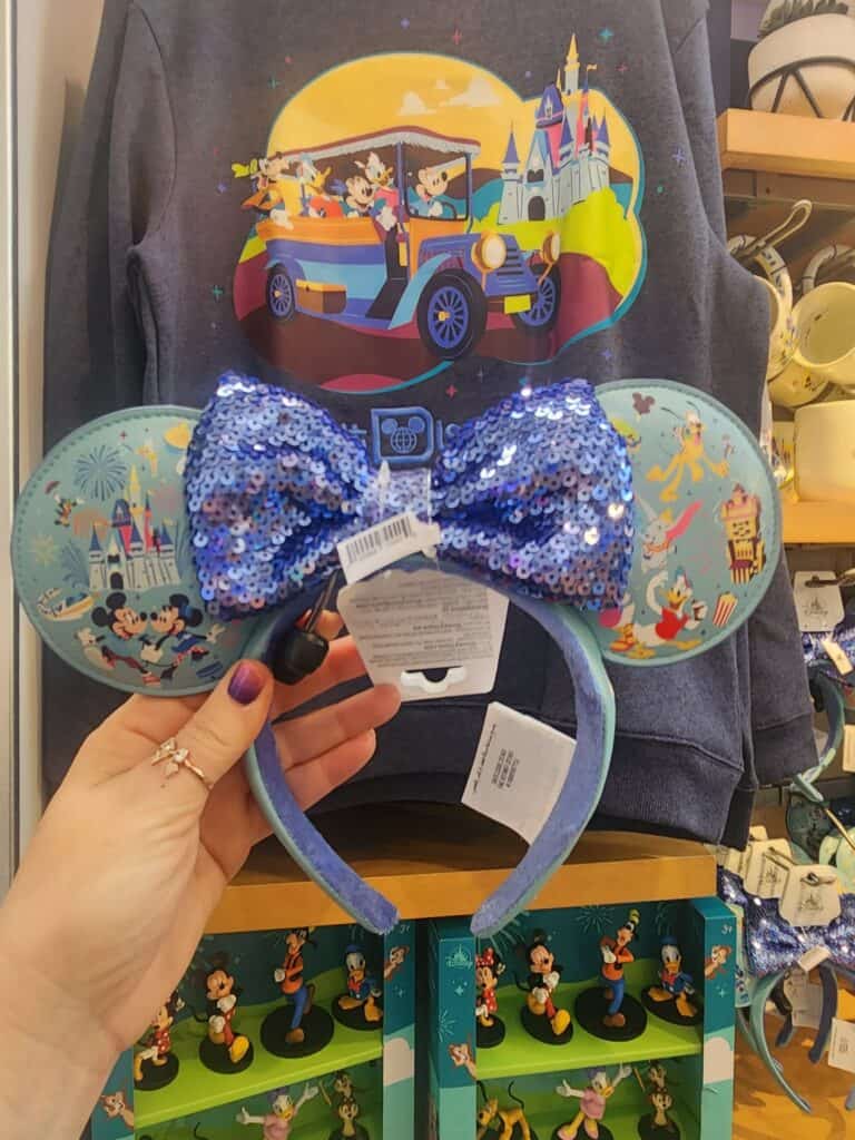 Bright Disney Mickey Mouse ears headband with sparkly blue sequin bow and themed cartoon ears.