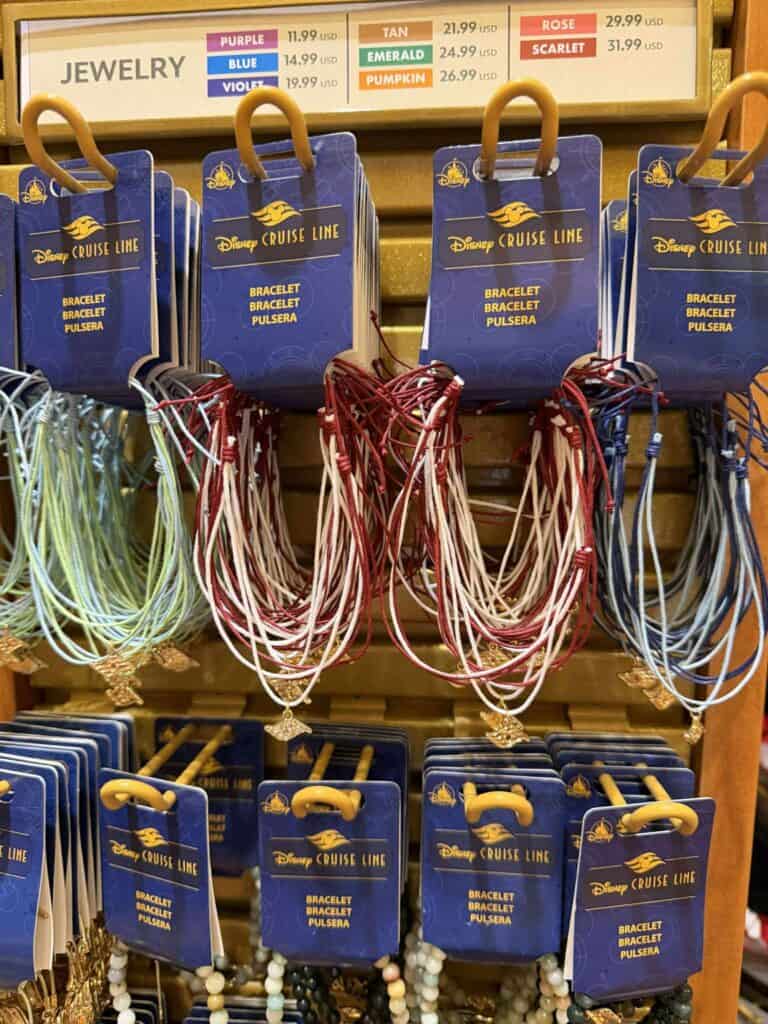 Brightly colored Disney Cruise Line jewelry bracelets necklaces on display, featuring various charms and designs.