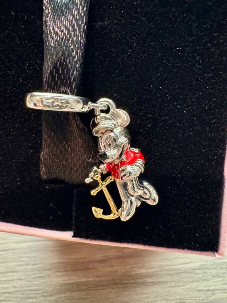 Detailed Minnie Mouse charm with anchor, red dress, and gold accents, perfect Disney jewelry piece.
