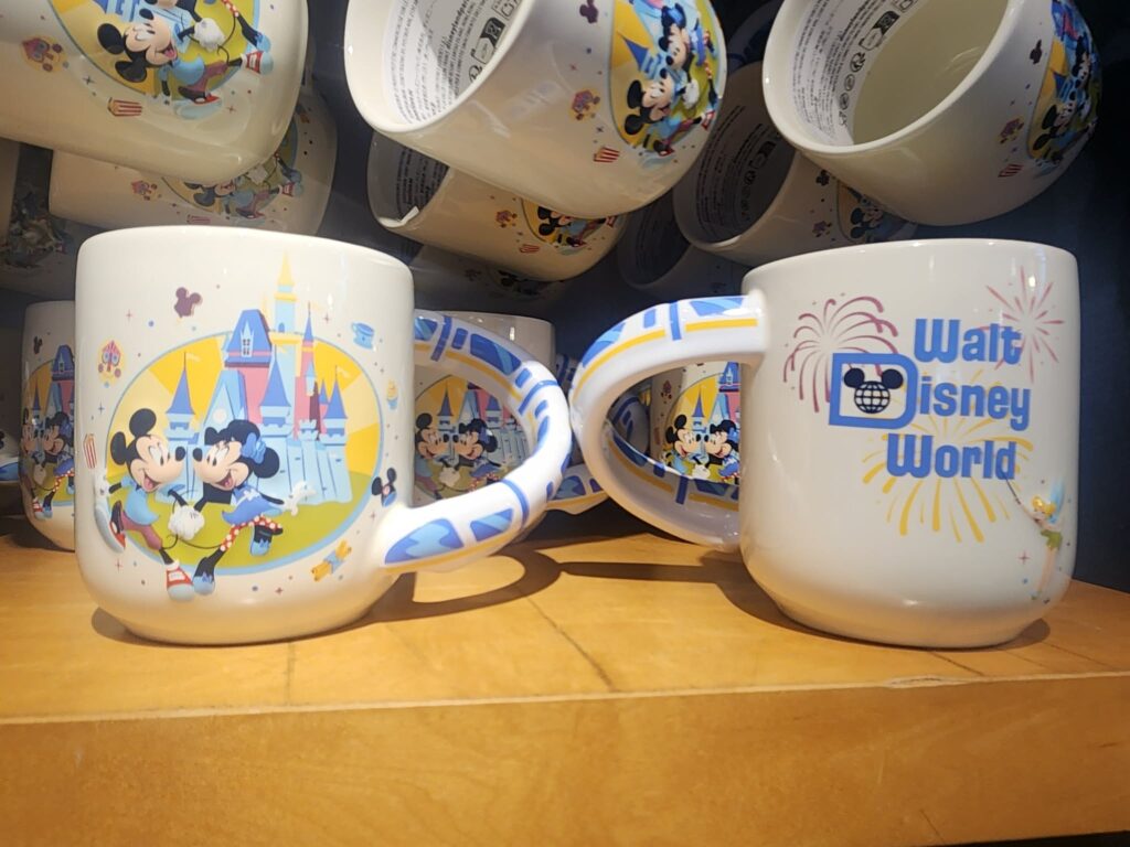 Colorful Disney Mickey and Minnie Mouse themed coffee mugs with Walt Disney World logo and castle design.