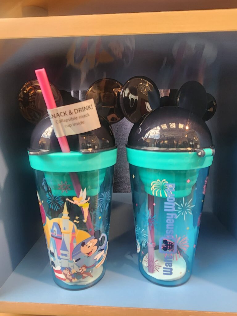 Colorful Disney Mickey Mouse snack cups with themed lids and straws, perfect for Disney fans and park visits.