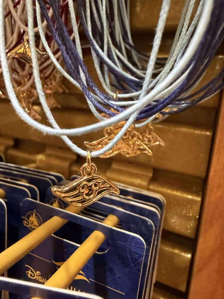 Delicate Disney jewelry featuring a gold flying fairy charm, ideal for Disney-themed accessories.