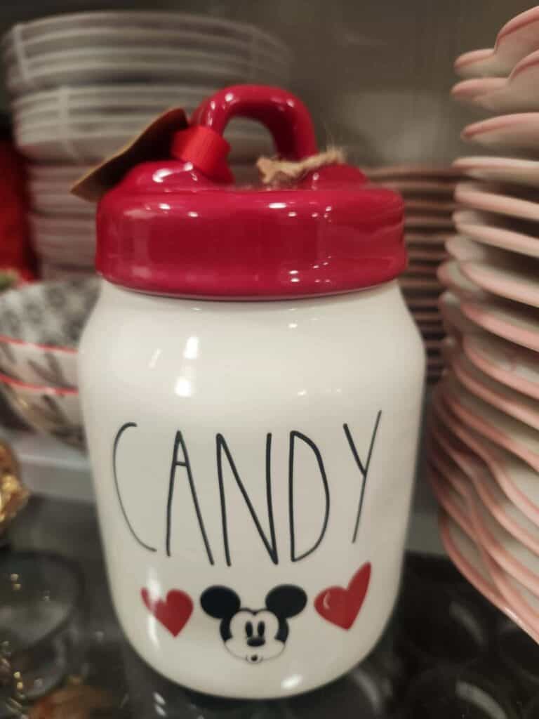 Decorative ceramic candy jar featuring Mickey Mouse and "CANDY" text, perfect for Disney fans.