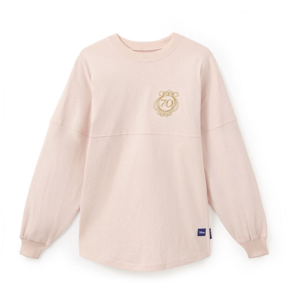 Soft pink Disney sweatshirt featuring gold "70" embroidery on the chest, celebrating Disney's anniversary.