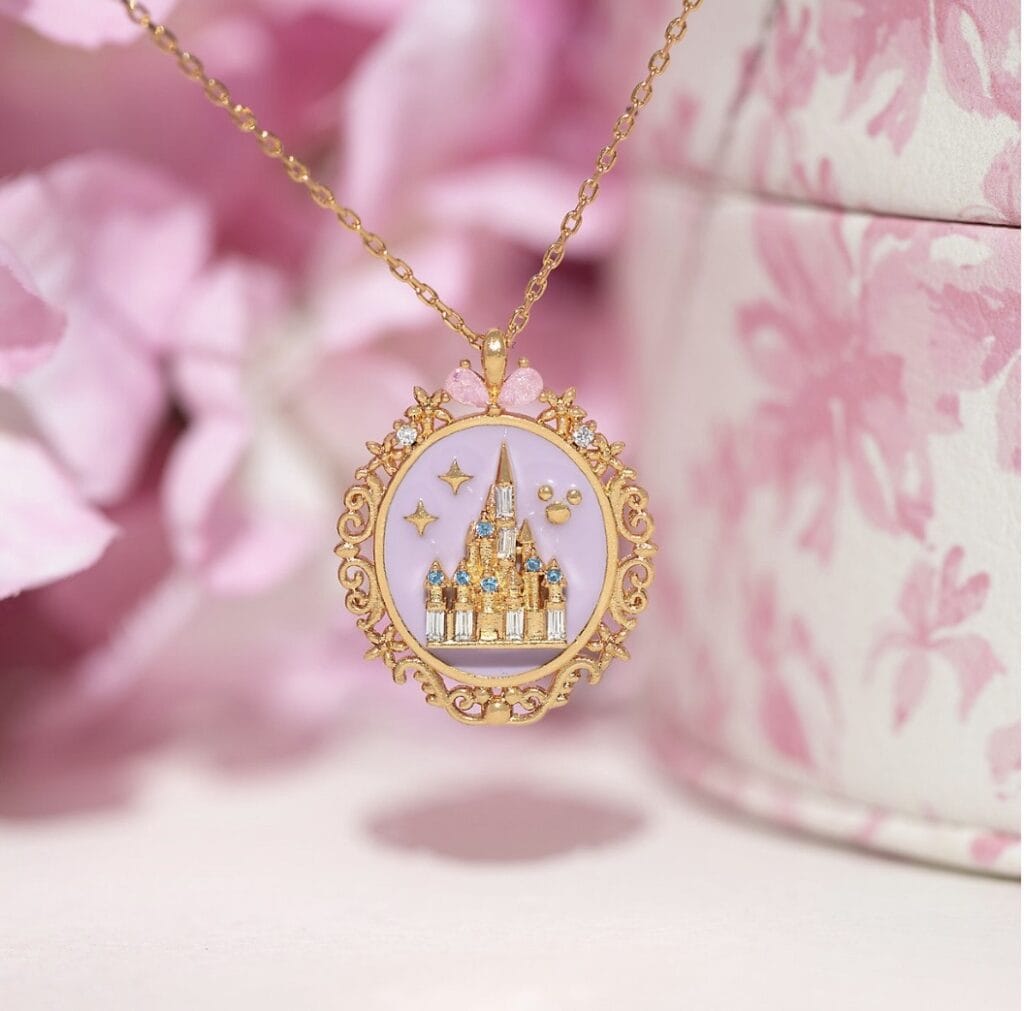 Sparkling miniature castle pendant with stars and gemstones, perfect Disney accessory.