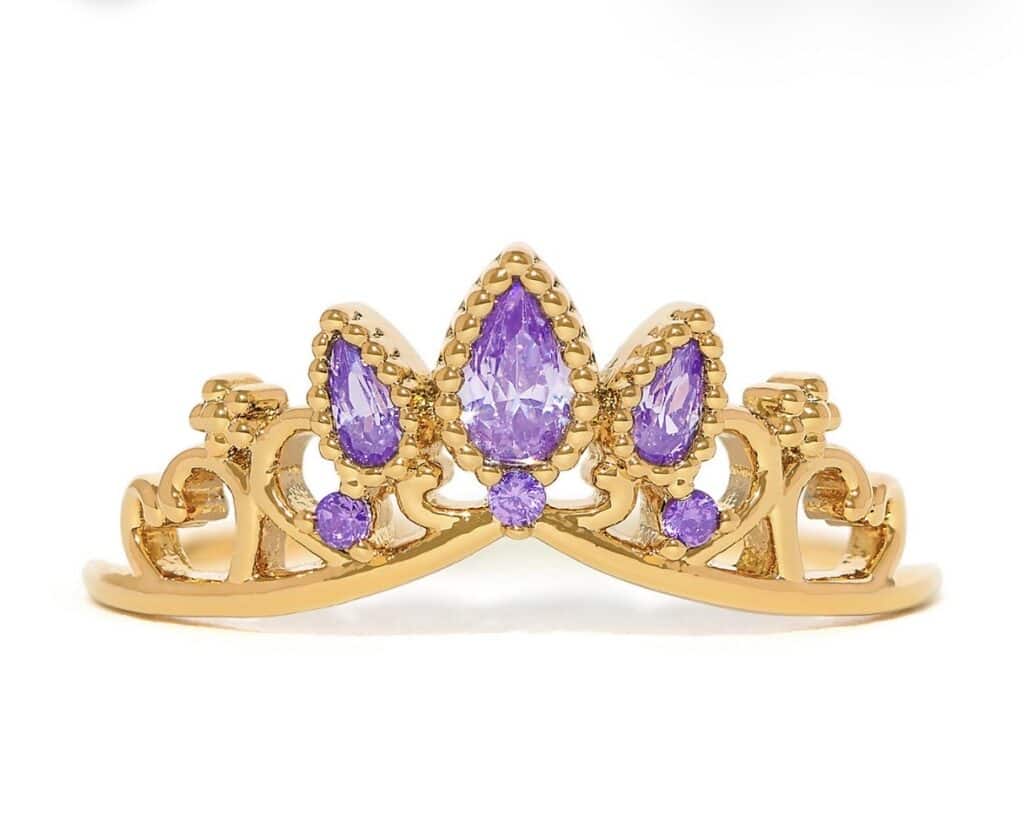 Elegant gold tiara with purple gemstones, perfect for Disney princess jewelry enthusiasts.