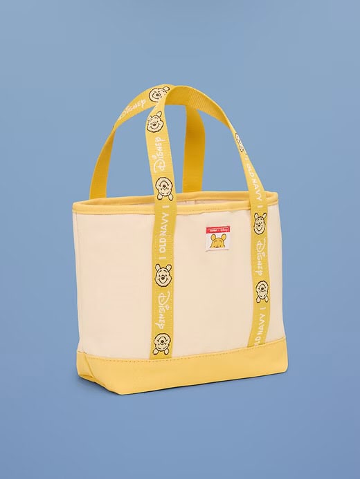 Bright yellow and white Disney-themed tote bag with bear face accents, perfect for casual outings and shopping.