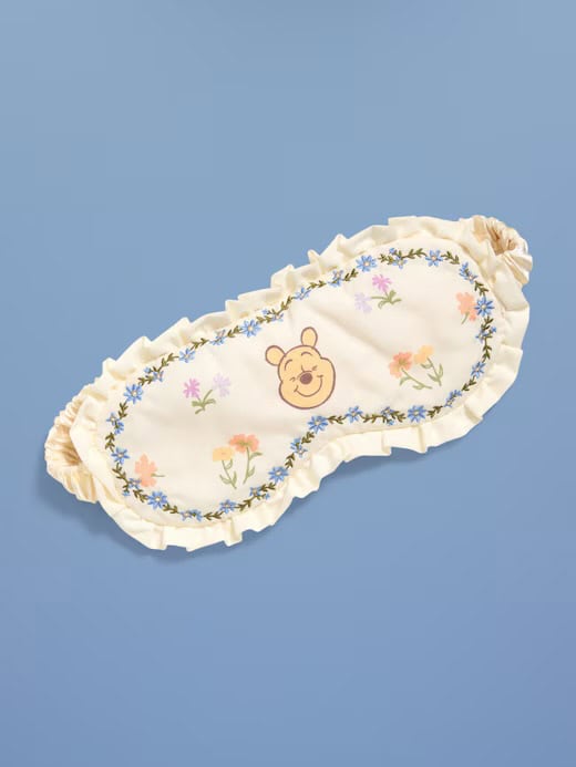 Soft sleep mask featuring Winnie the Pooh and floral embroidery for comfortable sleep.