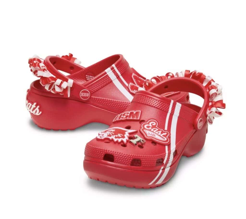 Red Disney-themed Crocs with varsity stripes and embellishments.