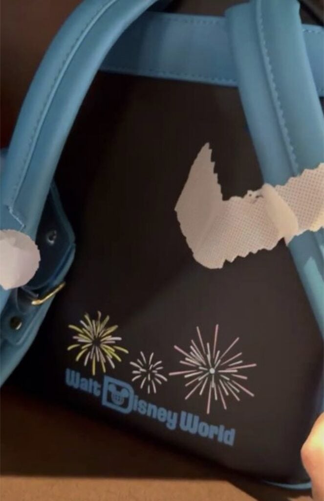 Bright blue Disney World-themed backpack with fireworks and map design. Perfect for Disney fans and park visits.