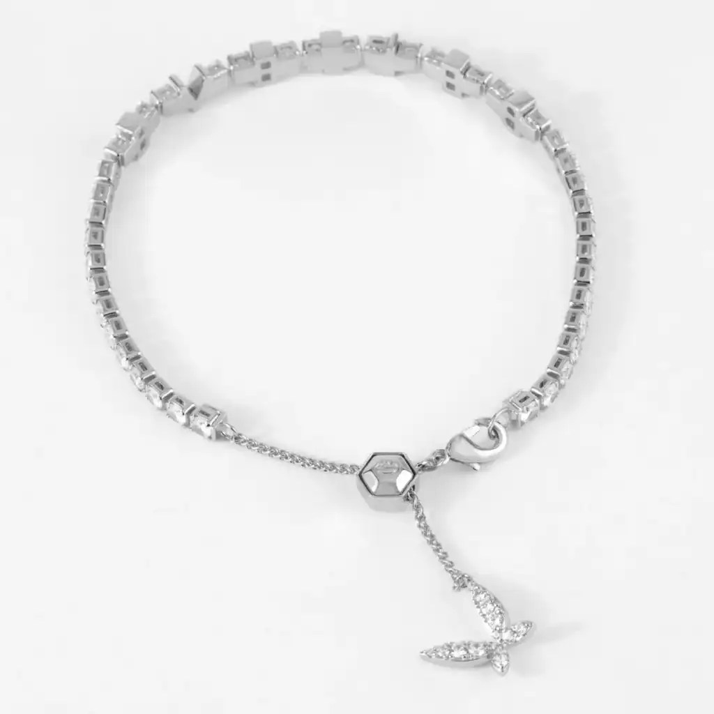 Silver bracelet with a bow-shaped charm and rhinestones, perfect Disney fashion accessory.