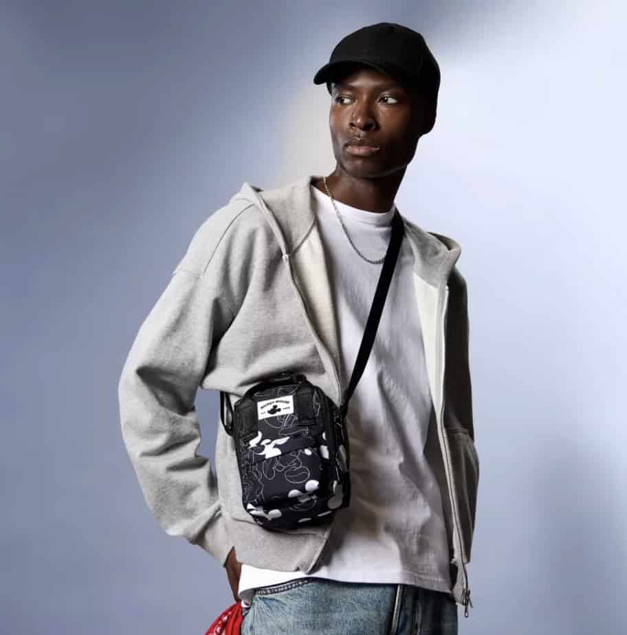 Fashionable Disney Mickey Mouse crossbody bag featuring iconic character print, perfect for Disney fans.