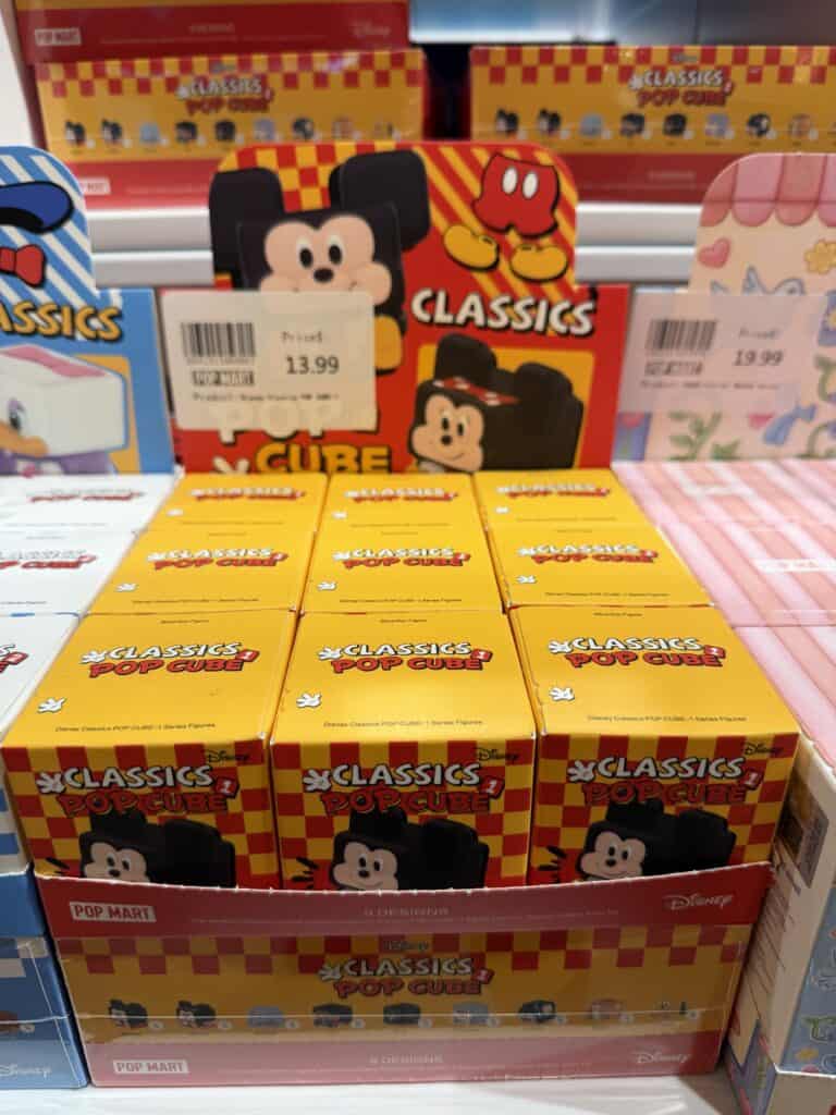 Colorful Mickey Mouse pop cube toy on store shelf.