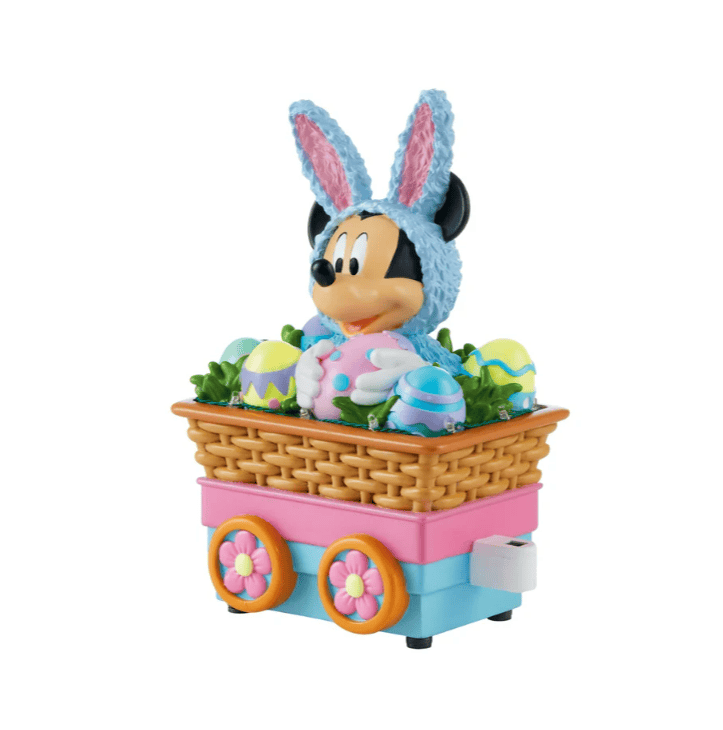 Cute Easter Mickey Mouse plush in bunny outfit with decorated eggs.