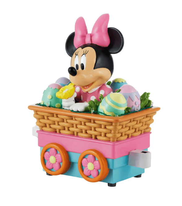 Colorful Easter Minnie Mouse with decorated eggs on a toy cart.