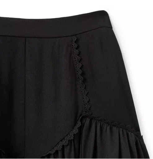 Close-up image of a stylish black skirt featuring delicate lace trim and ruffled hem, perfect for Disney-inspired fashion outfits.