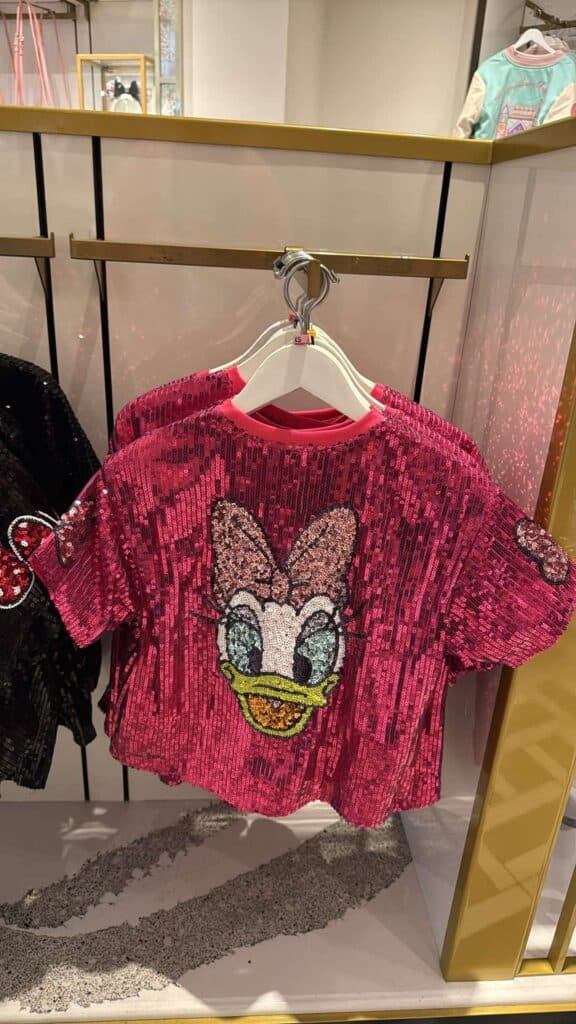 Bright pink kids' Disney sequin T-shirt featuring Minnie Mouse's cheerful face and sparkly details.