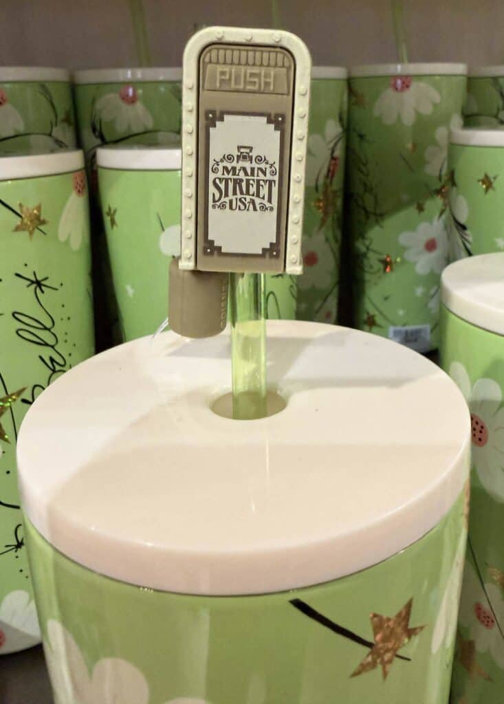 Colorful candy dispenser with "Main Street USA" theme and whimsical design. Perfect for nostalgic Disney decor and parties.