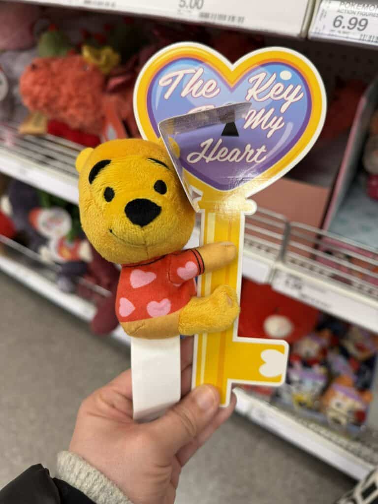 Plush Winnie the Pooh keychain with heart message.