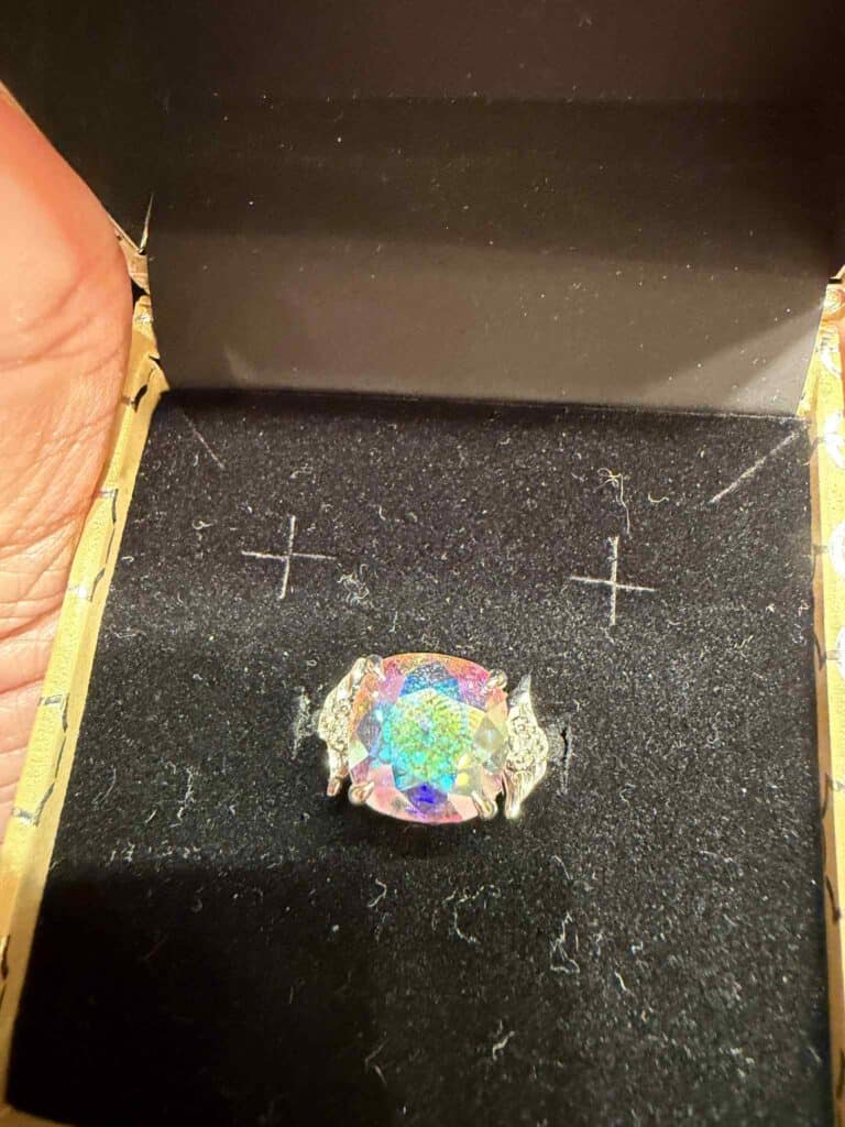 Elegant Disney-themed jewelry featuring a large, colorful, holographic stone with intricate silver detailing, perfect for Disney fans.