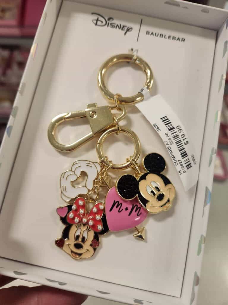 Colorful Disney Mickey Mouse and Minnie Mouse themed keychain with charms and pink heart details.