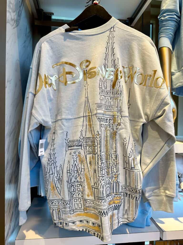 Disney World themed sweatshirt with castle graphic and metallic gold accents. Perfect Disney fashion for fans.