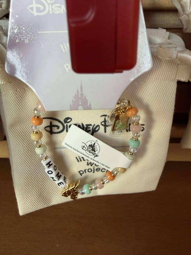 Colorful Disney-themed bracelet with unicorn charm and "Home" message, perfect for Disney fans.