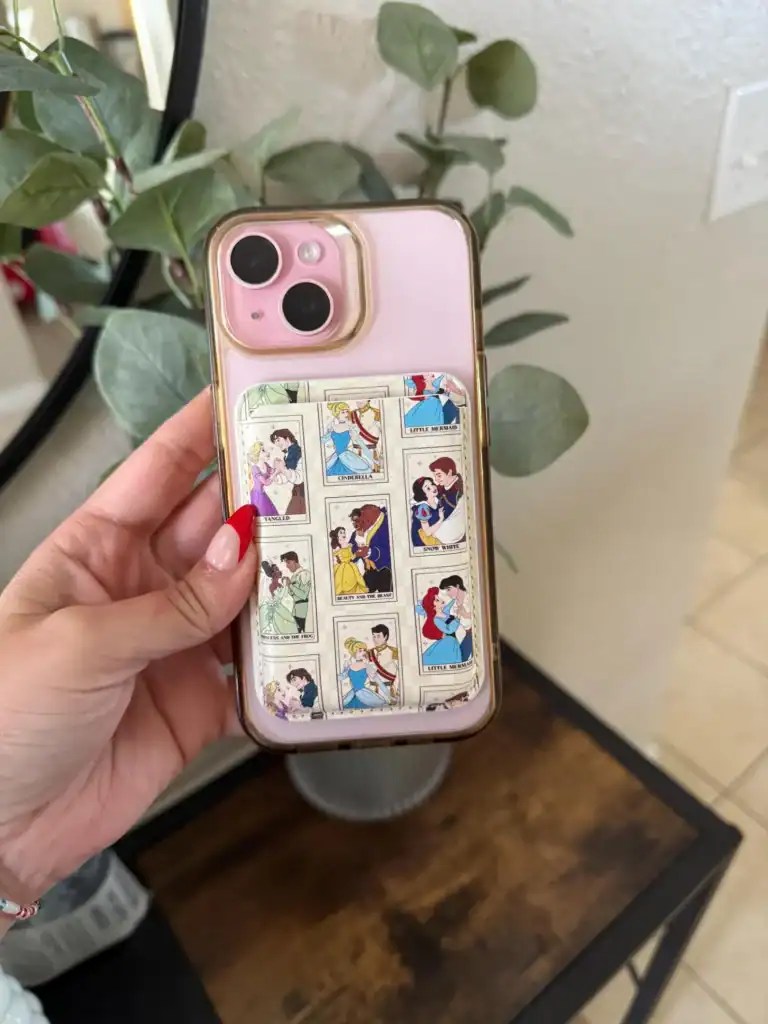 Colorful Disney princess artwork phone case with card holder for iPhone 13, featuring classic fairytale scenes.