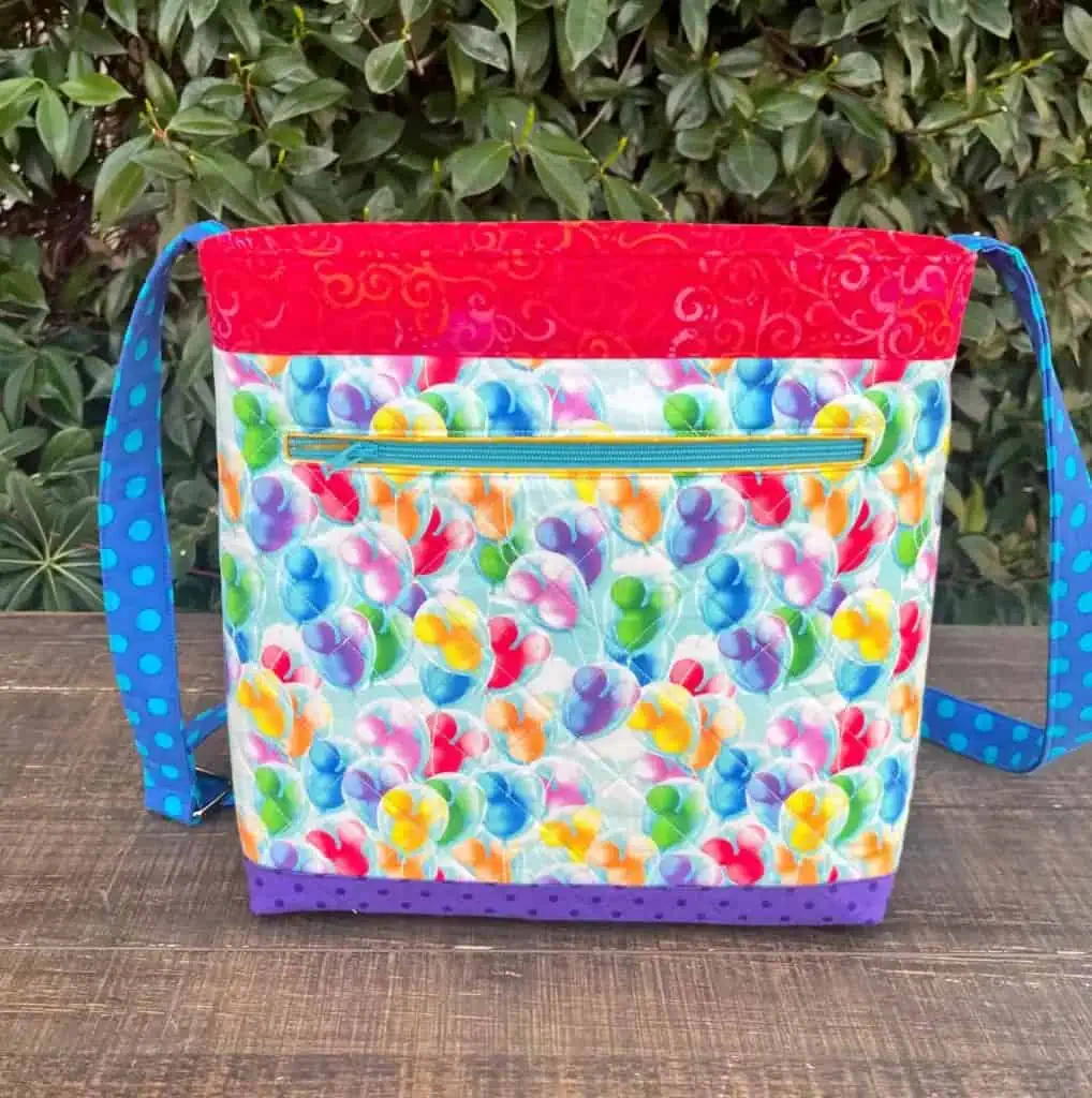 Bright Disney balloon print tote with rainbow accents, perfect for Disney fashion enthusiasts.