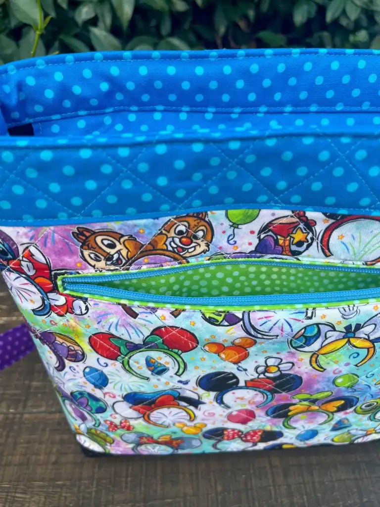 Brightly colored Disney character backpack featuring Mickey and Minnie Mouse with fireworks and balloons.