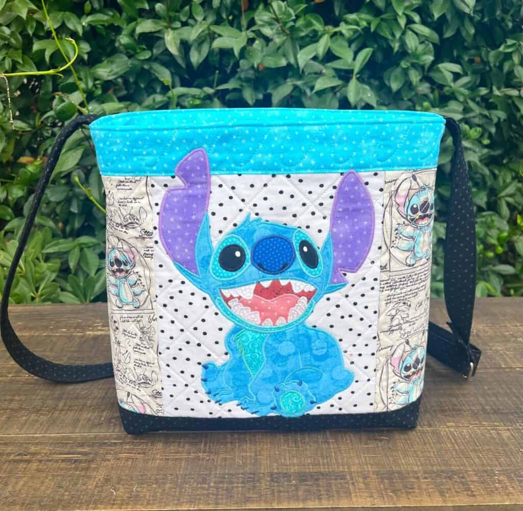 Bright blue and purple Stitch design on a white background, with Disney-themed side panels.