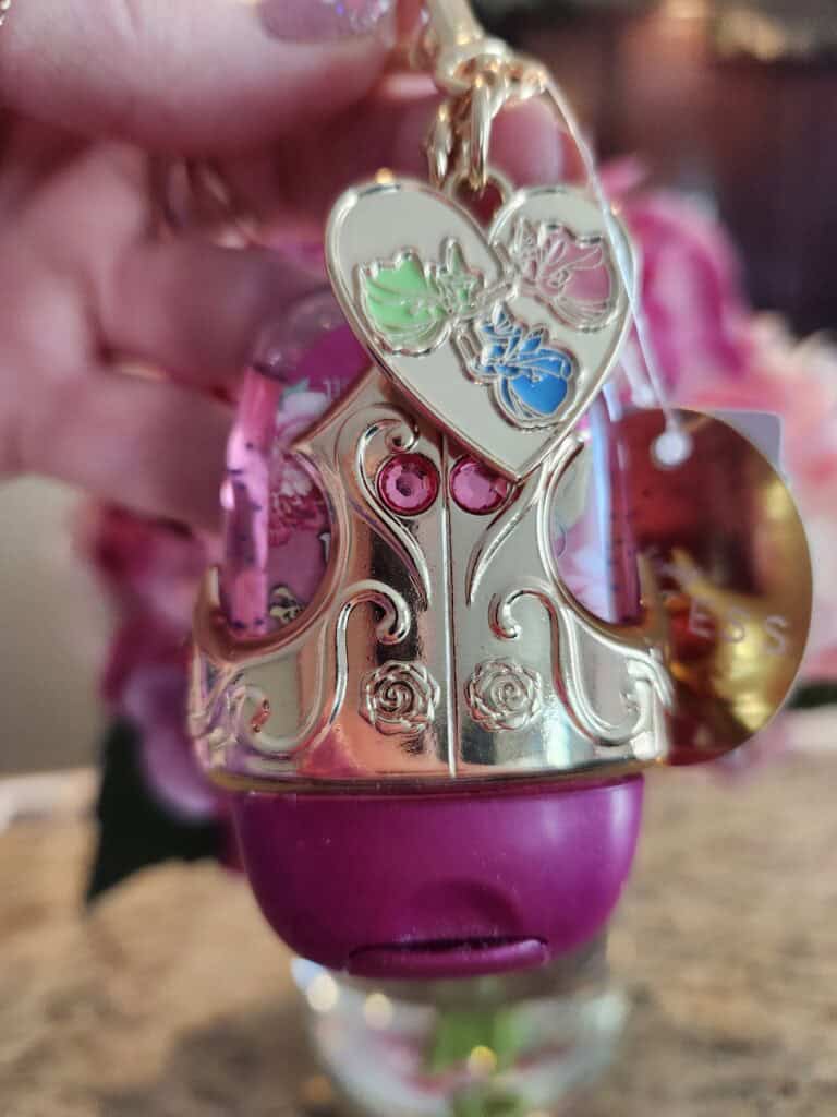 Keychain featuring Disney princesses and a pink bath bomb charm.