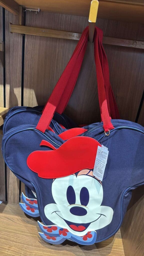 Bright blue Minnie Mouse themed bag with red accents and a large Minnie face graphic.