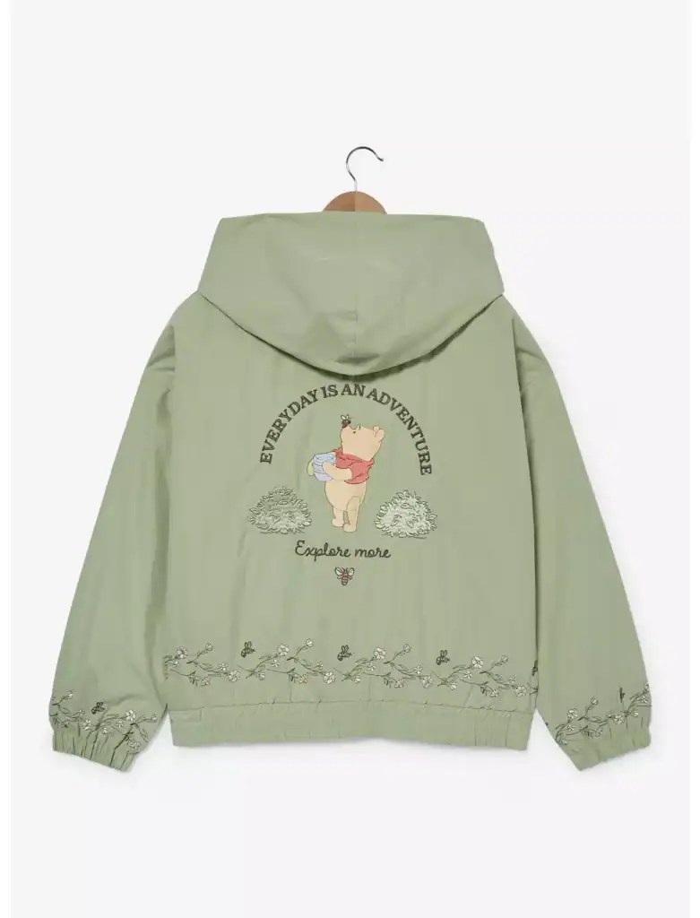 Light green Winnie the Pooh hoodie with adventure theme and floral details.