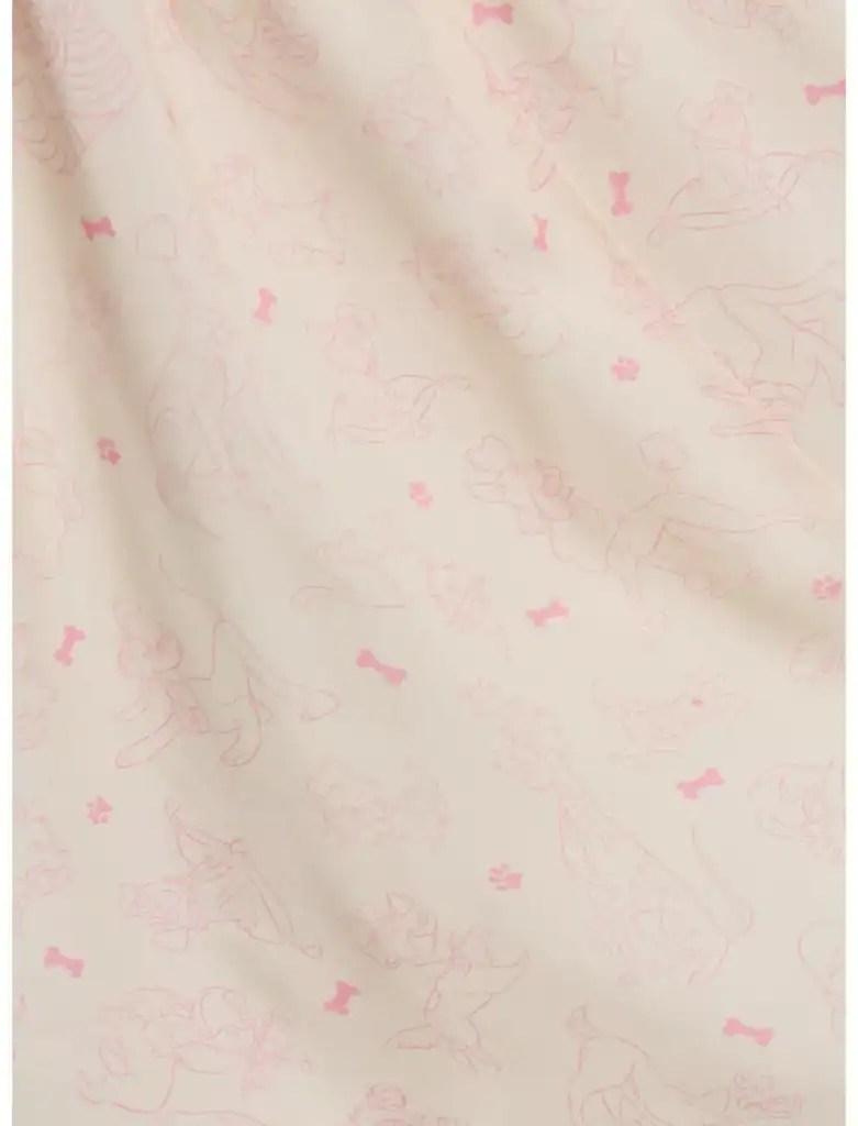 Disney characters pattern fabric in soft pink on cream background, perfect for fashion and craft pro.