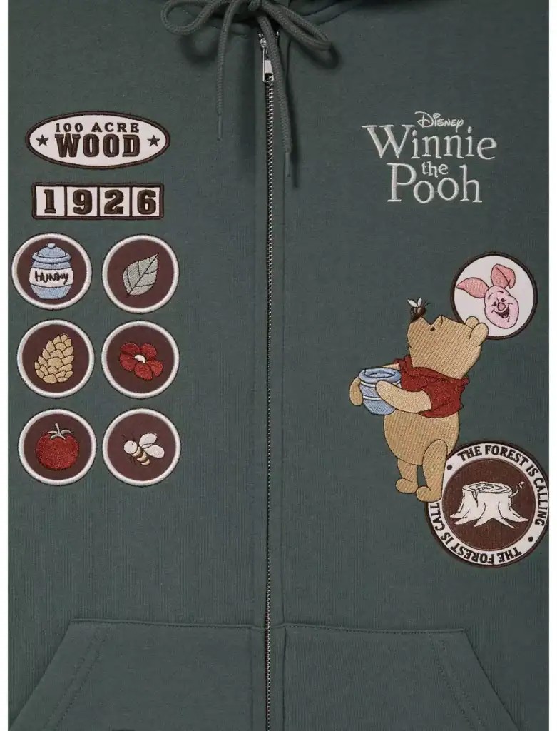 Cozy green Winnie the Pooh hoodie featuring forest club patch and wood-themed badges.