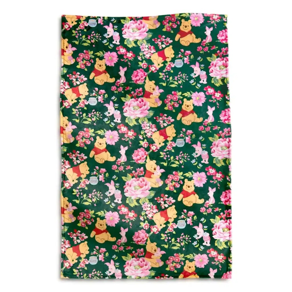 Colorful Winnie the Pooh floral fabric with pink flowers and cute characters.