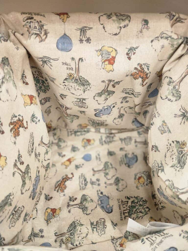 Disney fabric with classic characters and whimsical patterns for fashion or home decor.